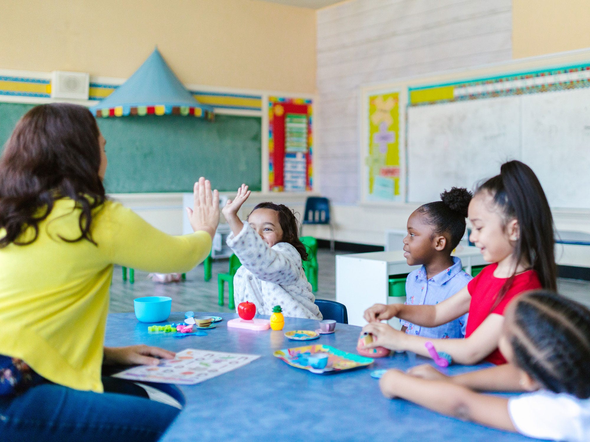 Teacher giving child high five