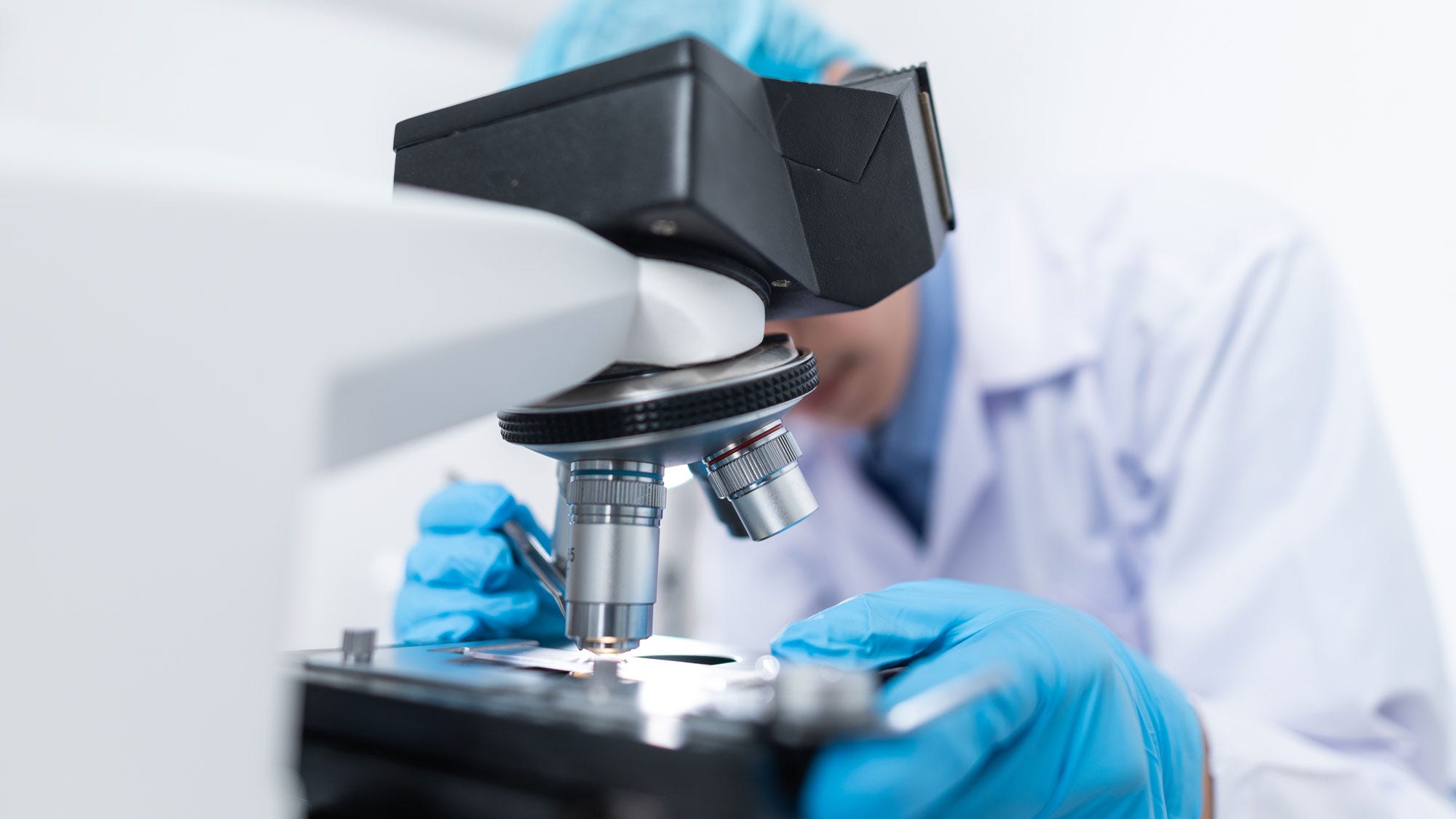 Man looking through microscope